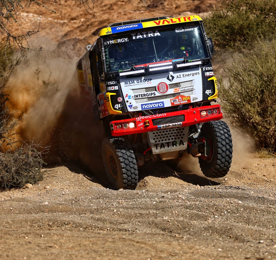 A Tatra throwing up a wall of dust in a bend, leaning onto its outer wheels