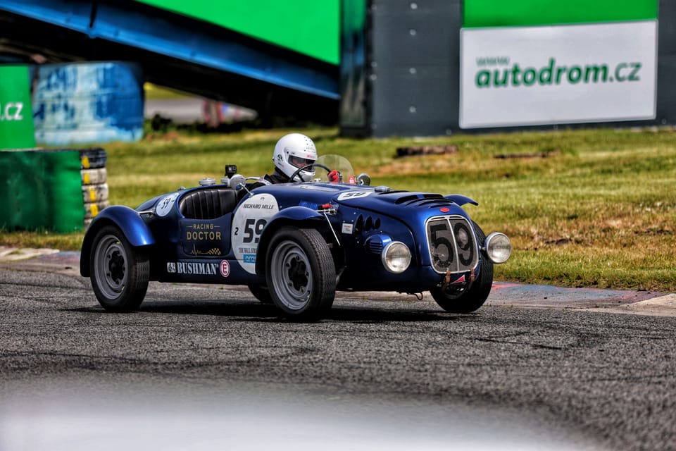 A dark blue pre-war special, number 59, taking a bend on the circuit